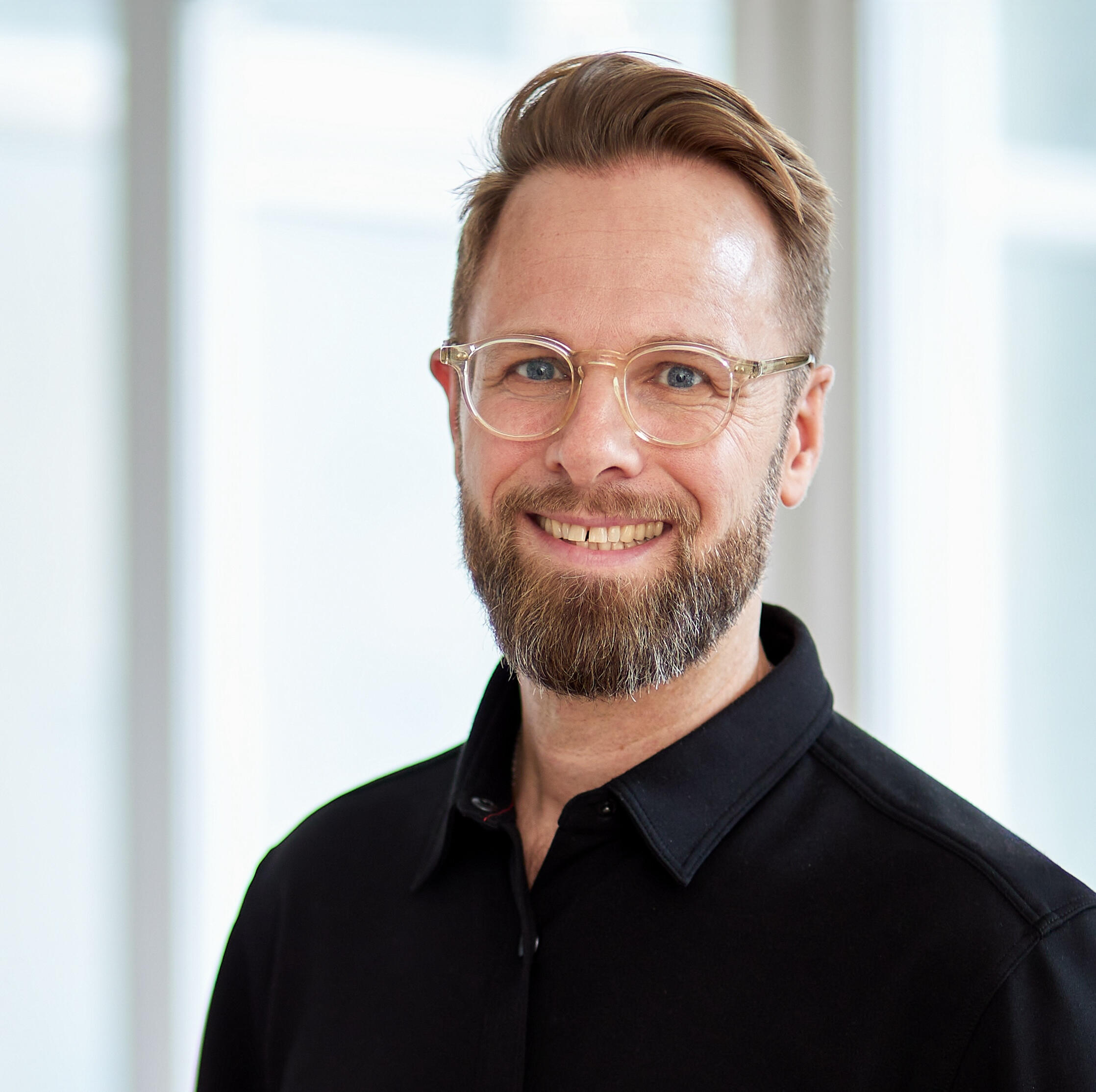 Martin Stahl Martin in front of a old fabric building window.